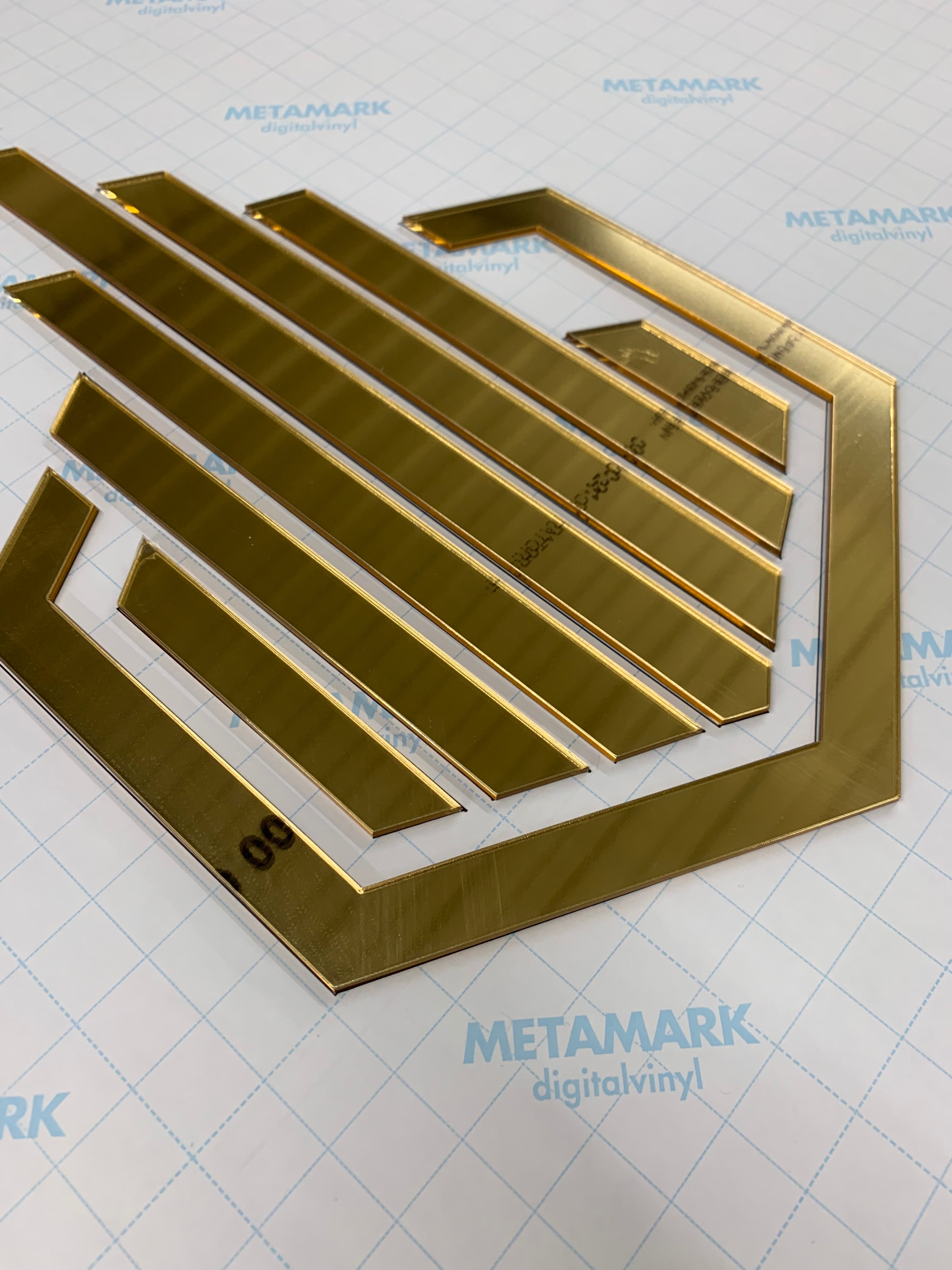 Laser cut mirror gold acrylic. Floating stand off logo.