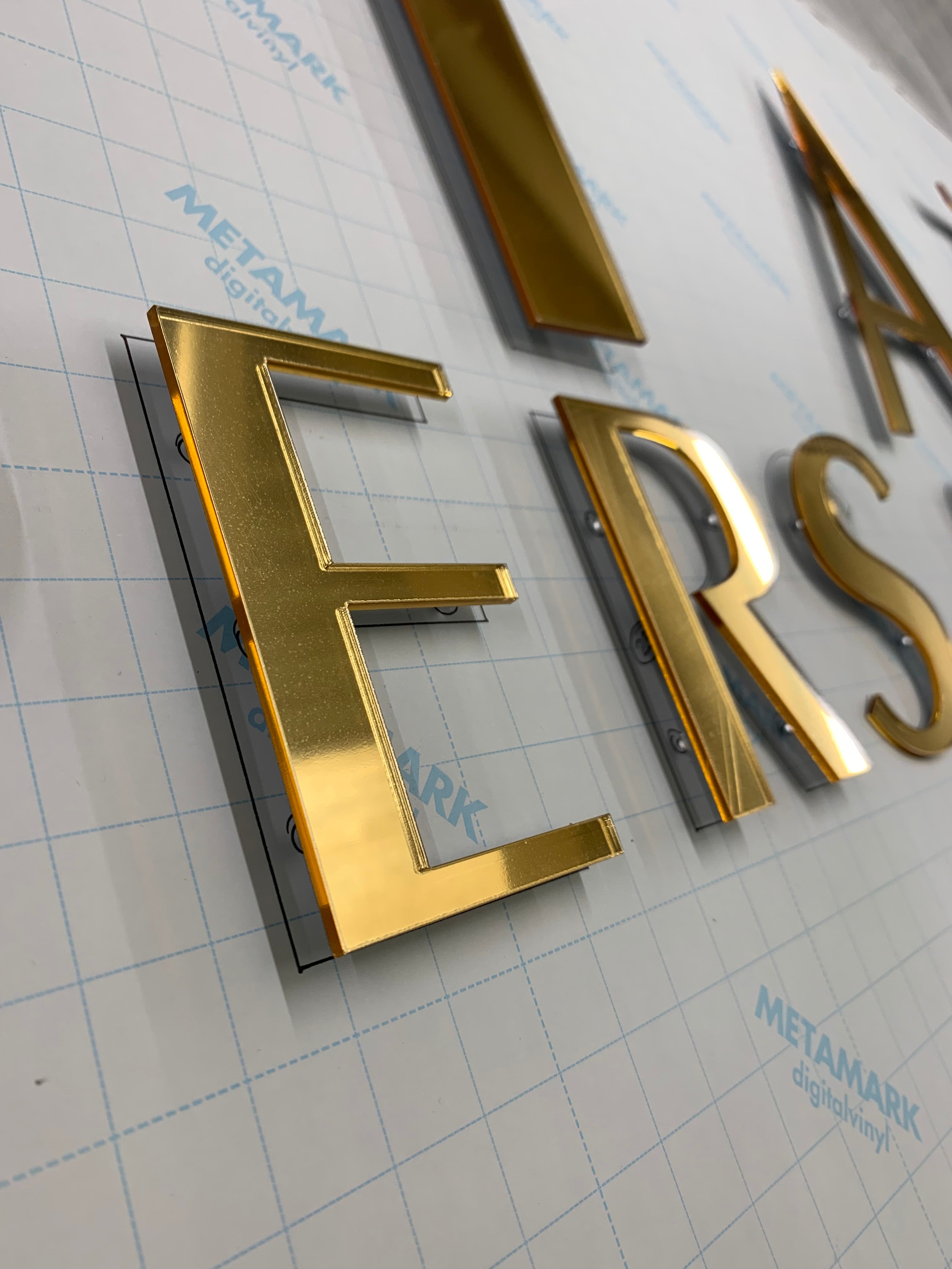 Laser cut mirror floating acrylic letters. On fitting template